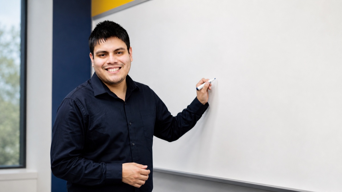 Instructor standing beside a clean classroom whiteboard